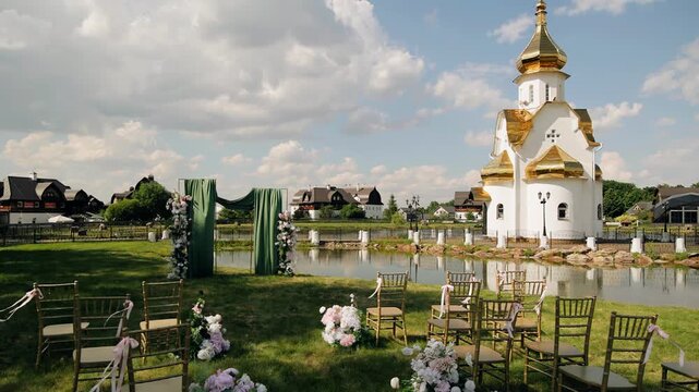 There is a beautiful pond and a wedding arch next to the church. Shooting in a picturesque place