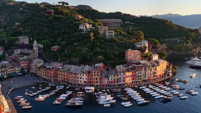 flying above a luxury resort town of Portofino in Italy, vacation on Italian Riviera, drone view of Ligurian coast, morning in Portofino