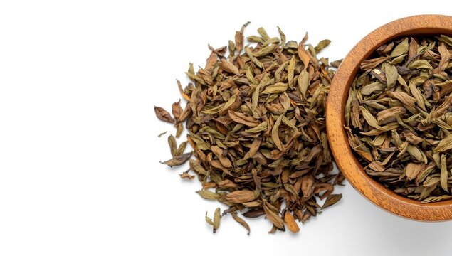 dry yerba mate tea stacked on a white background. dry yerba mate leaves in a wooden bowl.