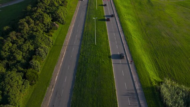 Aerial View of Dual Highway Framed by Green Fields and Forest