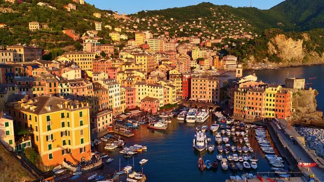 Drone view of the Ligurian resort town of Camogli, sunset in Liguria, Italy. Aerial view of Castello della Dragonara and Basilica di Santa Maria Assunta on Italian Riviera, luxury holiday in Italy