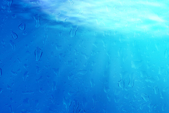 underwater deep blue sea abstract background with sun ray and reflection shadow on  sand for your abstract design.