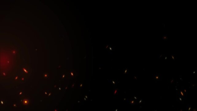 Abstract fire sparks embers flying upwards in dark intense warm energy motion background