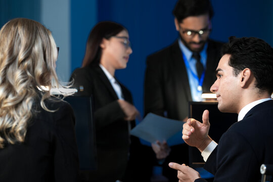 Data integrity check night shift Diverse team meticulously audits financial performance comparing figures tablet screen printed reports ensuring accuracy crucial validation process underway hub.
