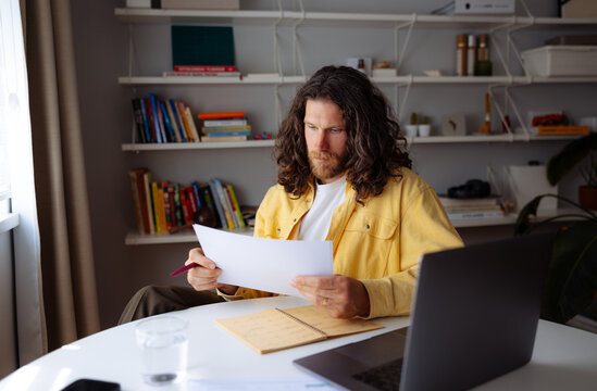 Focused Man Reviewing Paperwork 