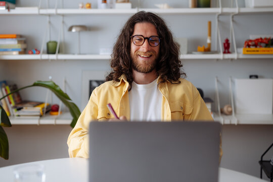 Man Working Remotely On Laptop In Home Office