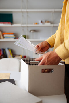 Packing Documents Into Cardboard Box In Home Office