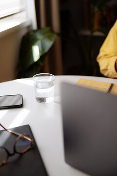 Minimal Home Workspace With Glass of Water