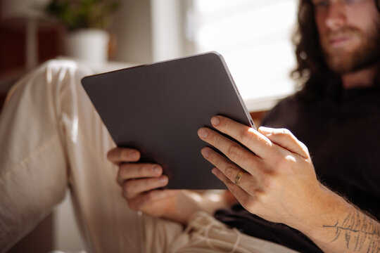 Man Reading on Tablet
