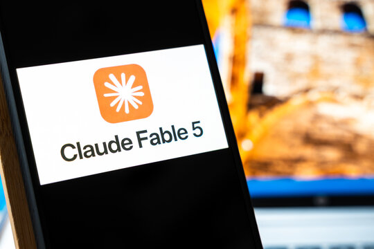 Warsaw, Poland - July 6, 2026: Mobile device displaying Claude Fable 5 logo on screen with additional background elements suggesting digital technology and creative design.