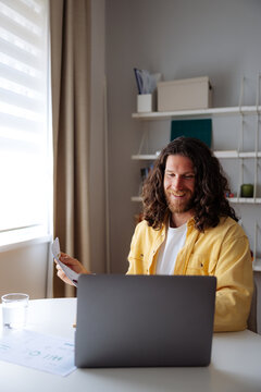 Smiling Man Working From Home On Laptop
