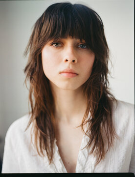 Young woman with long hair looking directly at the camera