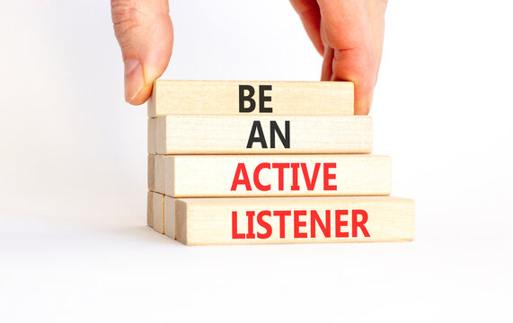 Be an active listener words symbol. Concept words Be an active listener on beautiful wooden blocks. Beautiful white background. Businessman hand. Business be an active listener concept. Copy space.