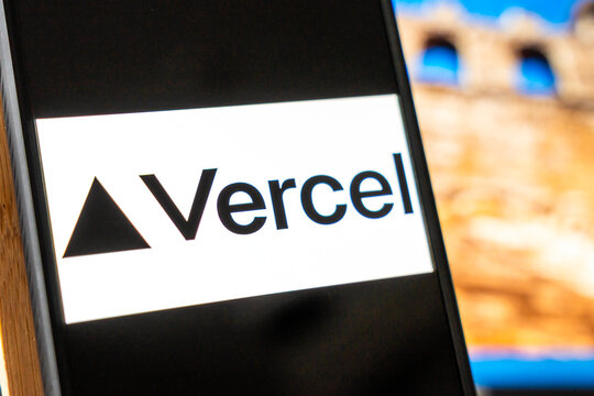 Warsaw, Poland - July 6, 2026: Close-up of Vercel logo displayed on a smartphone against an abstract background, representing technology and modern web development.