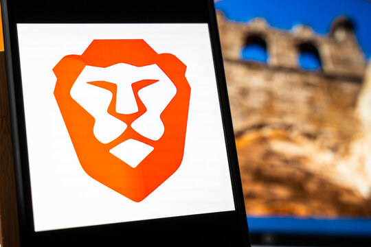 Warsaw, Poland - July 6, 2026: Close-up of browser logo displayed on smartphone screen with blurred historic building in the background, representing modern technology and online browsing.