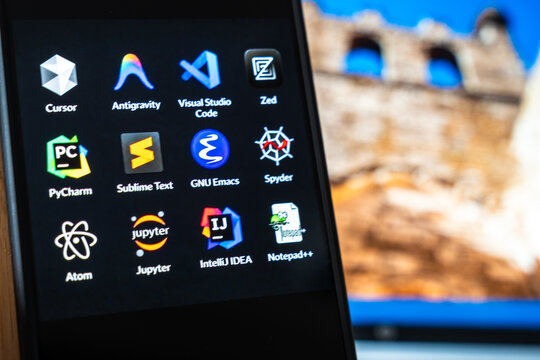 Warsaw, Poland - July 6, 2026: Close-up of software application icons displayed on laptop screen, highlighting various programming tools and environments.