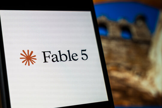 Warsaw, Poland - July 6, 2026: Close-up of Fable 5 logo displayed on smartphone screen with blurred historic castle backdrop, illustrating branding in modern digital age