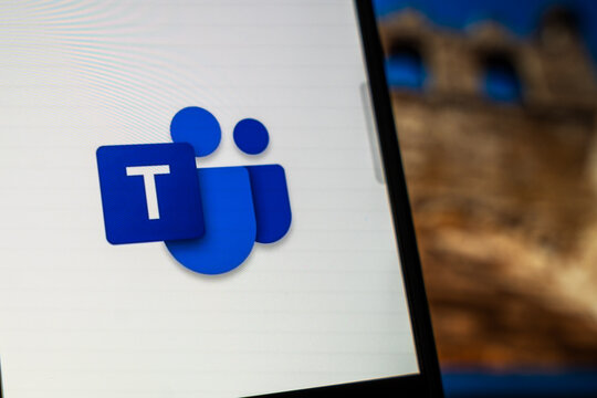 Warsaw, Poland - July 6, 2026: Close-up of Microsoft Teams application logo displayed on smartphone screen with blurry building in the background, representing modern communication and collaboration 