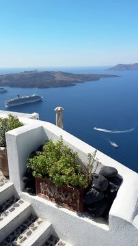 White architecture in Santorini island, Greece. Blue sea and the blue sky at sunny day. Luxury resort. Travel and summer vacation concept. Vertical video
