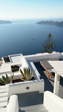 White architecture in Santorini island, Greece. Blue sea and the blue sky at sunny day. Luxury resort. Travel and summer vacation concept. Vertical video
