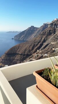 White architecture in Santorini island, Greece. Blue sea and the blue sky at sunny day. Luxury resort. Travel and summer vacation concept. Vertical video
