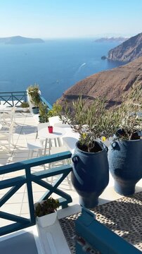 White architecture in Santorini island, Greece. Blue sea and the blue sky at sunny day. Luxury resort. Travel and summer vacation concept. Vertical video
