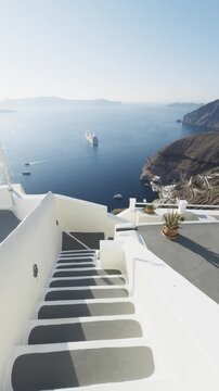 White architecture in Santorini island, Greece. Blue sea and the blue sky at sunny day. Luxury resort. Travel and summer vacation concept. Vertical video
