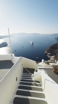 White architecture in Santorini island, Greece. Blue sea and the blue sky at sunny day. Luxury resort. Travel and summer vacation concept. Vertical video
