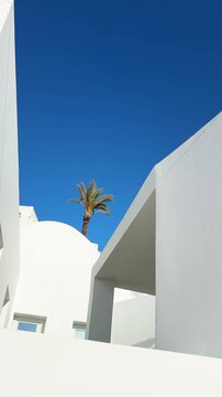 Santorini island, Greece. White cycladic architecture against the blue sky at sunny day. Vertical video
