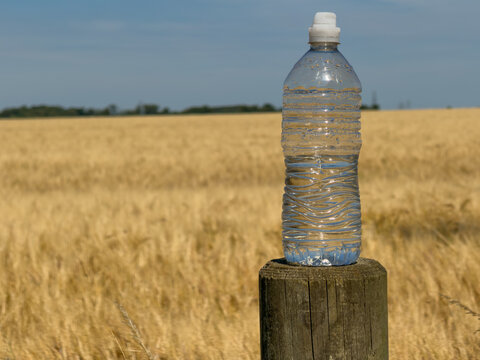 bottle of water on a fence post 