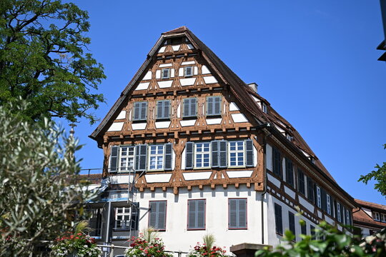 Half-timbered gabled house facade with blue shutters