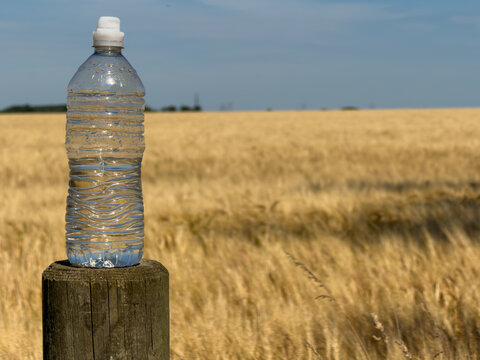 bottle of water on a fence post 
