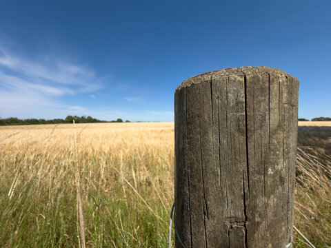 old wooden fence surrounding a field 