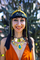 Obraz premium Girl at a carnival. A woman in a Cleopatra costume looks at the camera and smiles. Purim holiday.