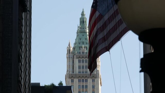 New York City Woolworth building 1913, skyscraper on Broadway in Downtown Financial District, Lower Manhattan, United States of America. Gothic historic architecture, cooper roof, USA american flag.