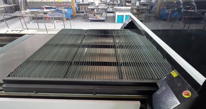 CNC Laser Cutting Machine Processing Aluminum Sheet Metal. Industrial Laser Cutting of Metal Sheets in Factory Workshop. Metal processing and metal cutting workshop. Production site