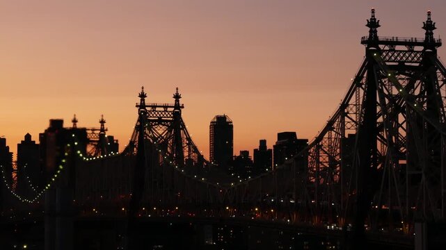 New York City Manhattan Midtown skyline from Queens, Queensboro bridge architecture, United States. Rooftop cityscape from Long Island Hunters Point. Urban sunset twilight dusk dark evening silhouette