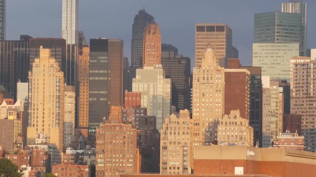 New York City Manhattan Midtown skyline from Queens, United States. Skyscraper buildings architecture, cityscape from rooftop in Long Island, Hunters Point. Early morning sunrise golden hour sun light