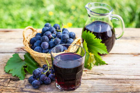 Grape juice in the glass and pitcher