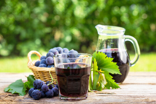 Grape juice in the glass and pitcher