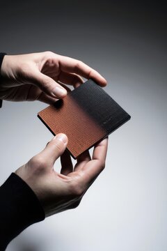 Hands holding textured material sample for chiplet design selection