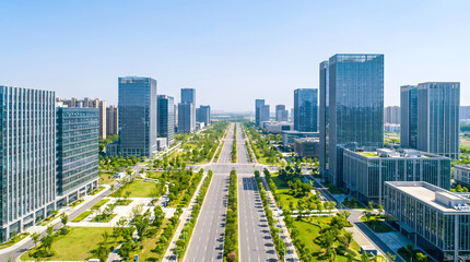 Fototapeta premium Modern urban central avenue flanked by tall glass buildings with symmetrical green landscaping and orderly traffic lanes