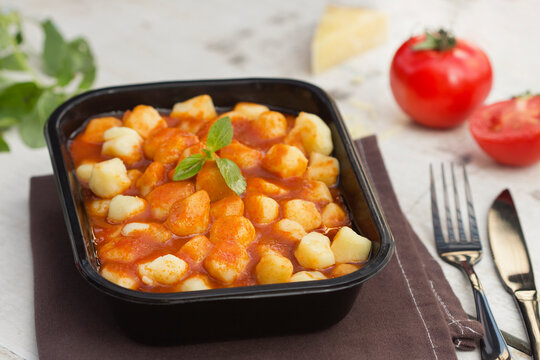 Black Dish with Gnocchi Casserole and Fresh Herbs