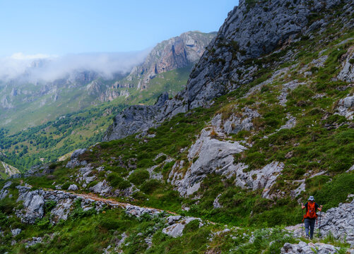 Hiker walking on Mount Camba in Picos de Europa National Park Spain