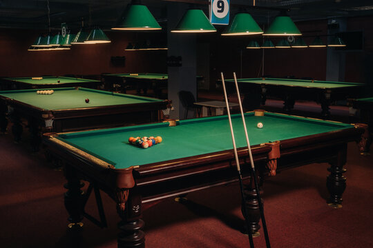 Billiard table with green surface and balls in the billiard club.Pool Game