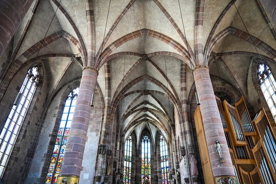 Gothic cathedral interior with ribbed vaults and pipe organ
