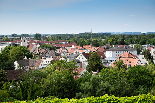 Panoramic small town rooftops with trees and church tower