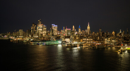 Obraz premium New York landscape city view. NYC night cityscape with Manhattan skyline. New York City panoramic skyline scene. New York cityscape waterfront skyline. NYC aerial skyline above downtown Manhattan.