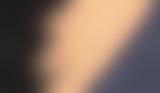 Soft light filters through a textured surface. Warm glow contrasts against dark, shadowed edges.