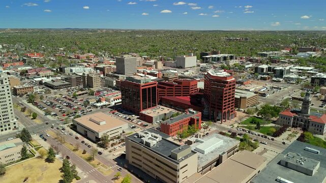 Drone orbiting historic courthouse with prominent clock tower in Colorado Springs downtown